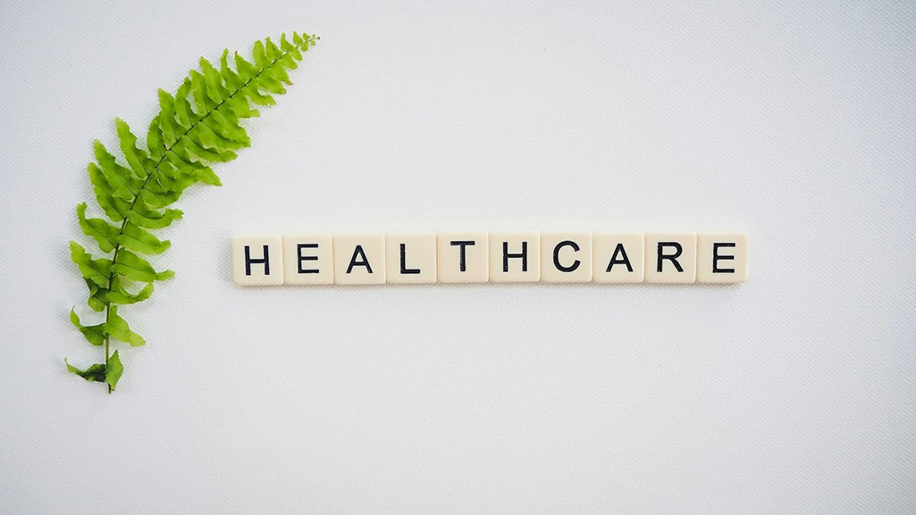 Tile on a flat surface spelling “healthcare”